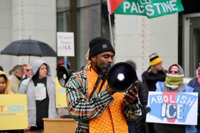 Speaker addressing demonstrators with a megaphone